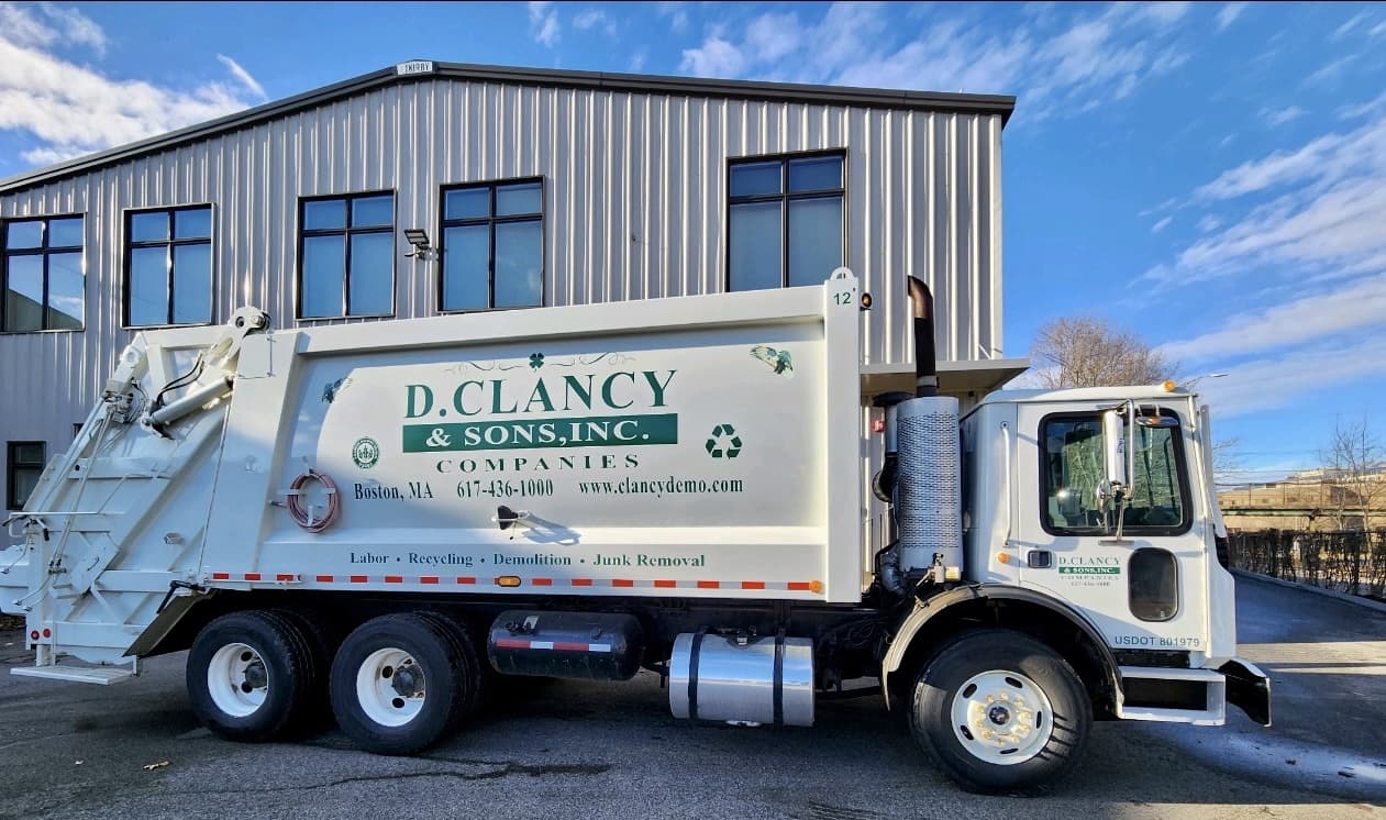 D. Clancy & Sons compactor truck used for construction debris removal